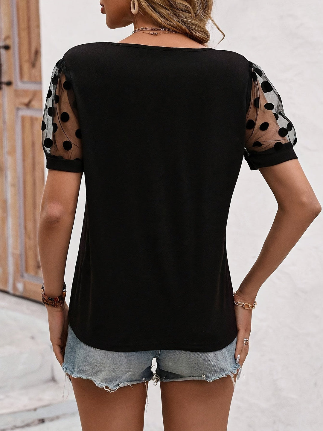 Danna - Elegant Black T-shirt with Trendy Dotted Sleeves